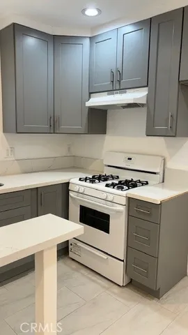 a kitchen with a sink stove top oven and cabinets
