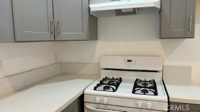 a kitchen with a stove and a refrigerator