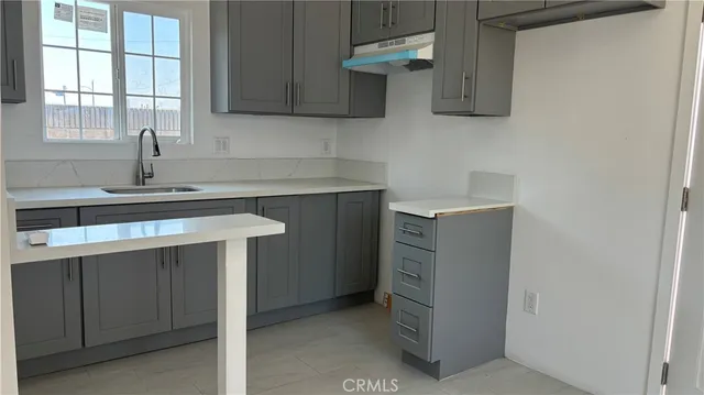 a kitchen with a sink cabinets and window