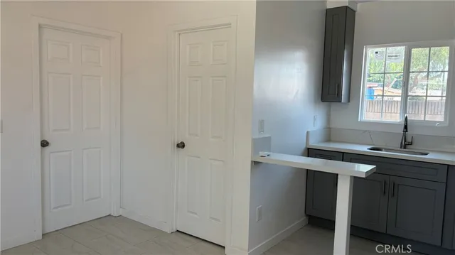 a kitchen with a stove and white cabinets