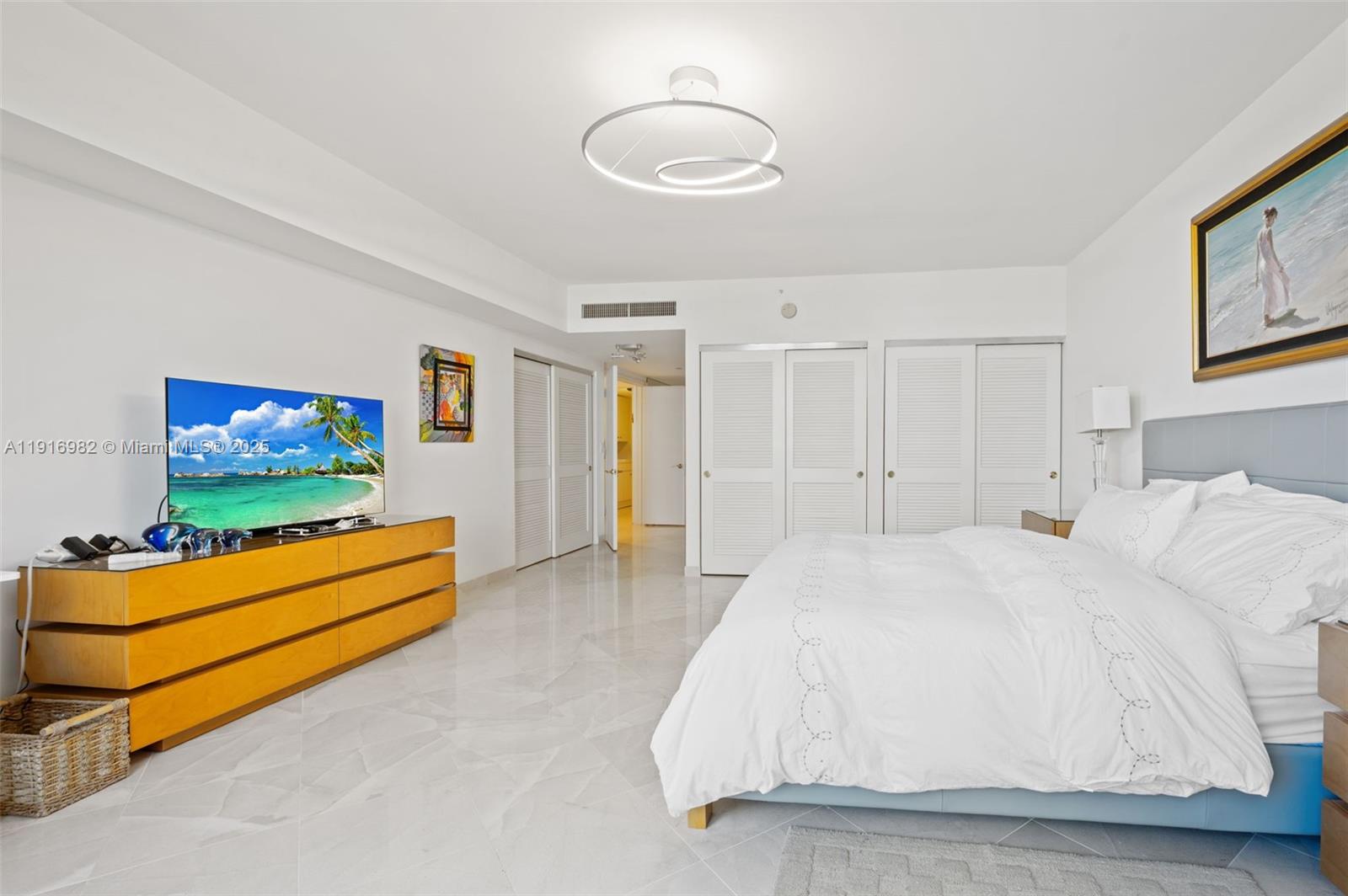 9595 Collins Avenue, Unit N8A Surfside, FL 33154 - Photo 13 of 25 a bed room with a bed and a television