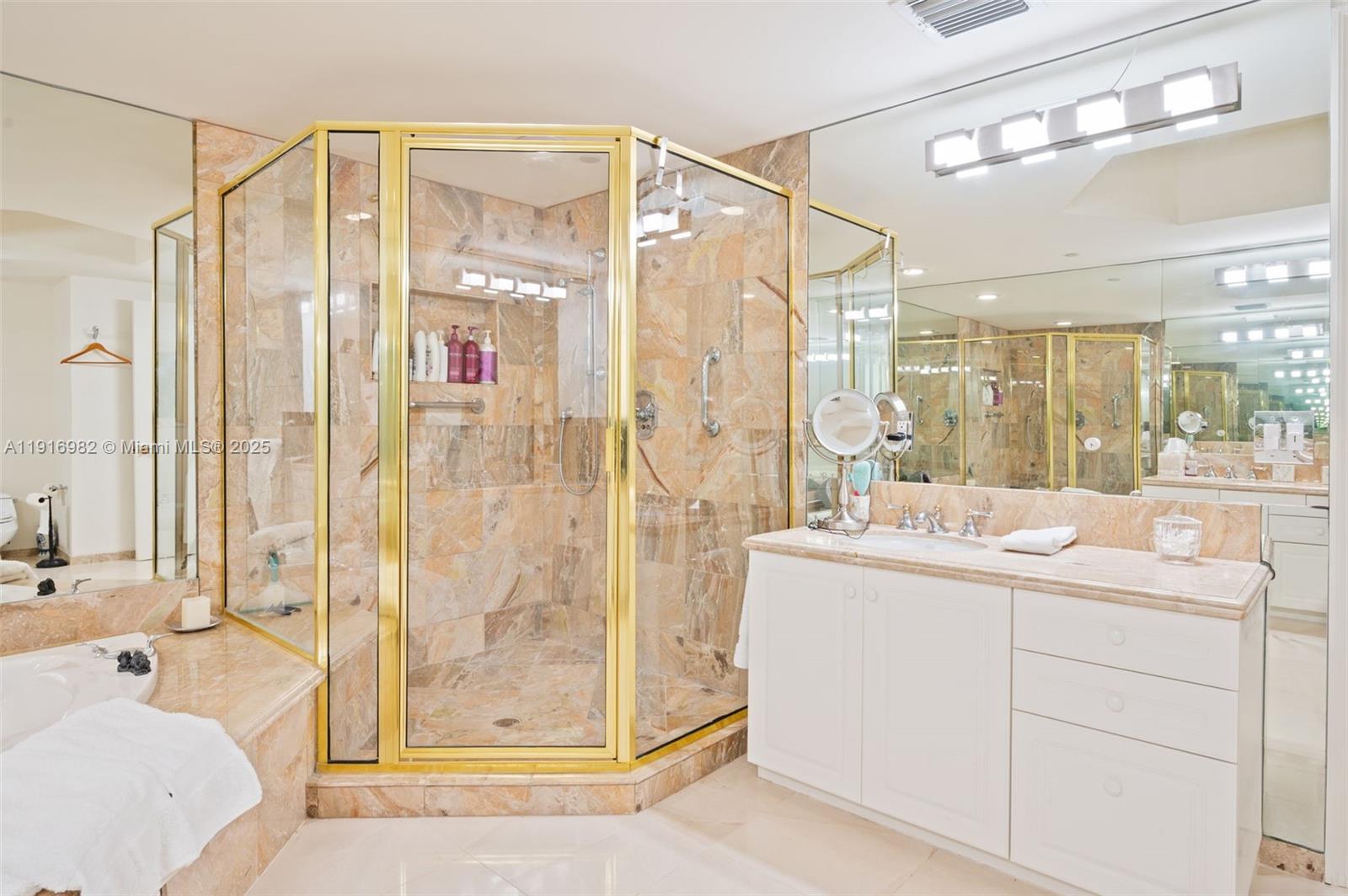 9595 Collins Avenue, Unit N8A Surfside, FL 33154 - Photo 16 of 25 a bathroom with a shower sink and mirror