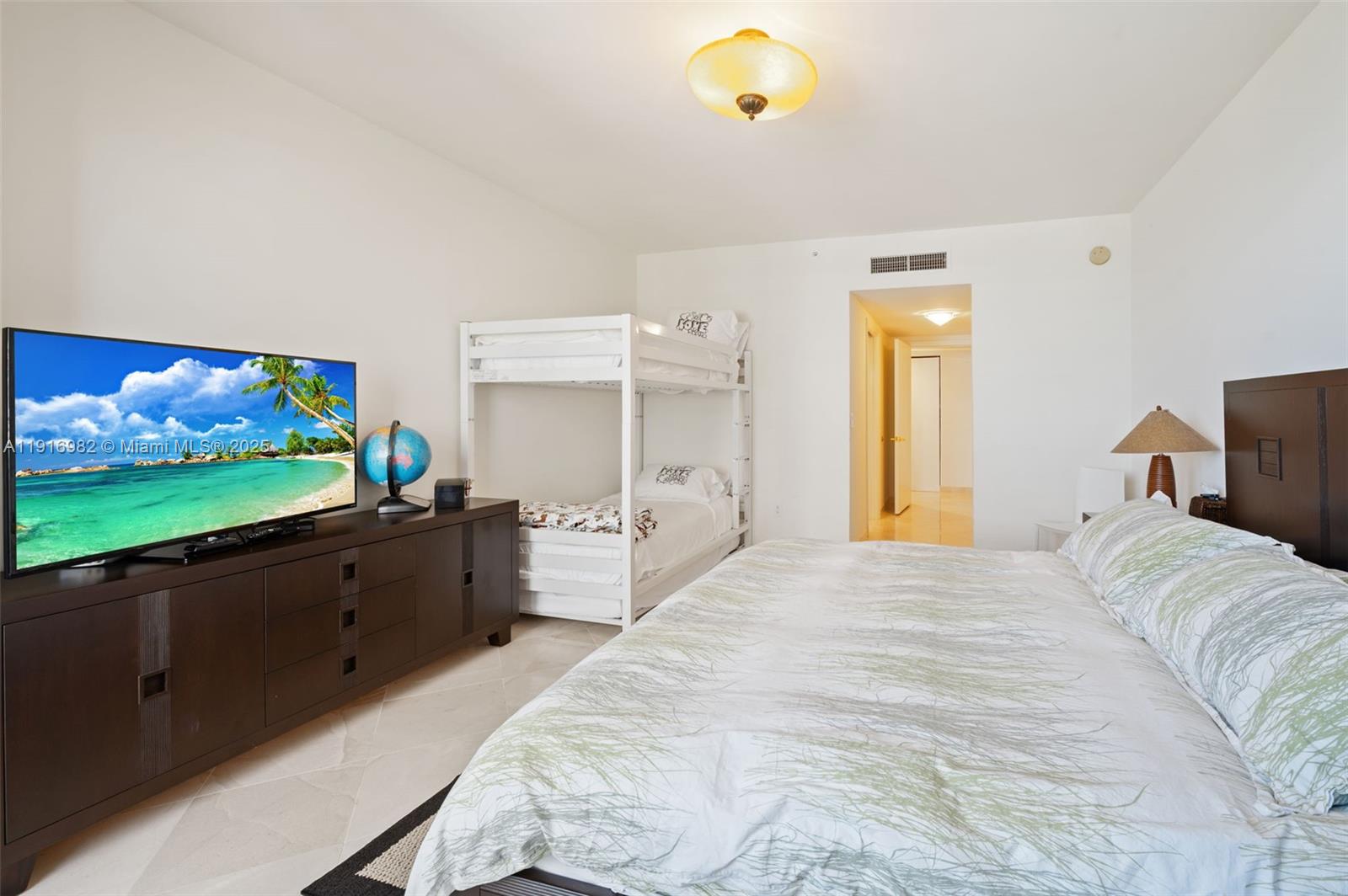 9595 Collins Avenue, Unit N8A Surfside, FL 33154 - Photo 18 of 25 a large bedroom with a bed and wooden floor