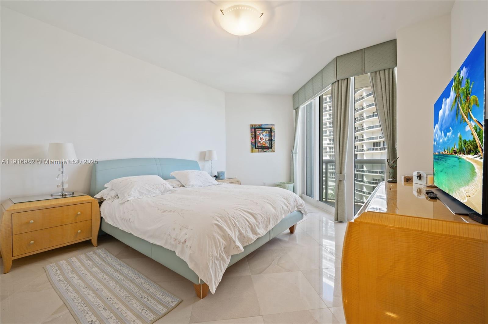 9595 Collins Avenue, Unit N8A Surfside, FL 33154 - Photo 20 of 25 a bedroom with a bed and a couch