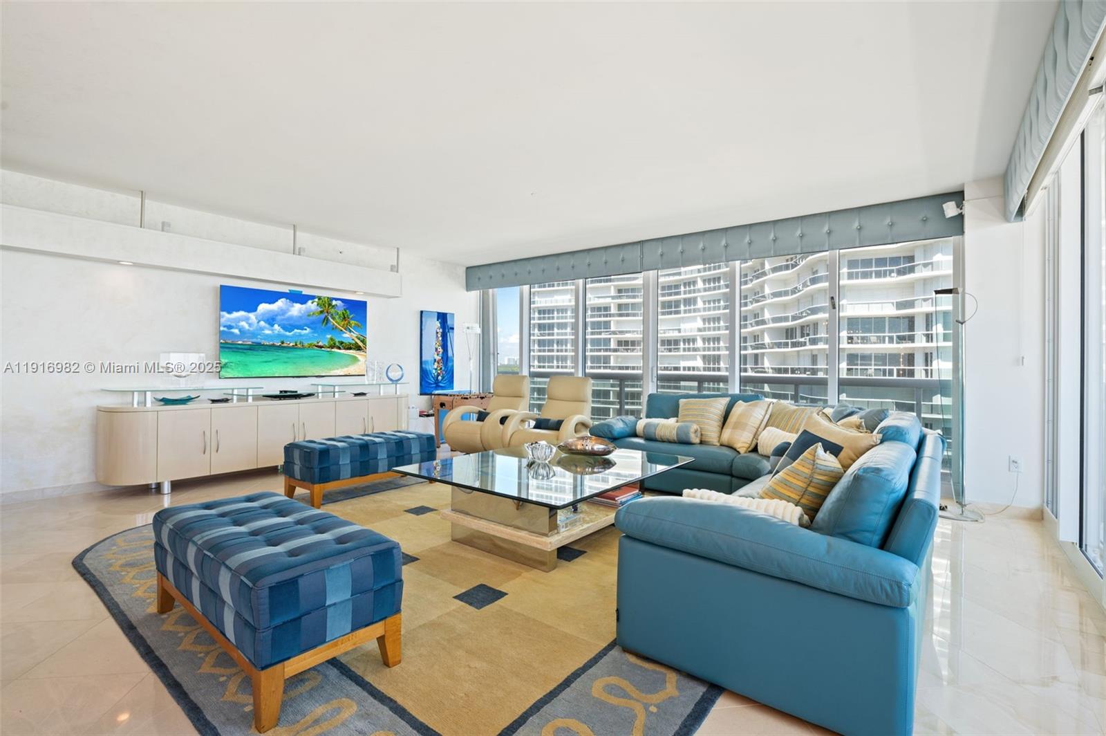 9595 Collins Avenue, Unit N8A Surfside, FL 33154 - Photo 6 of 25 a living room with furniture floor to ceiling window and a flat screen tv