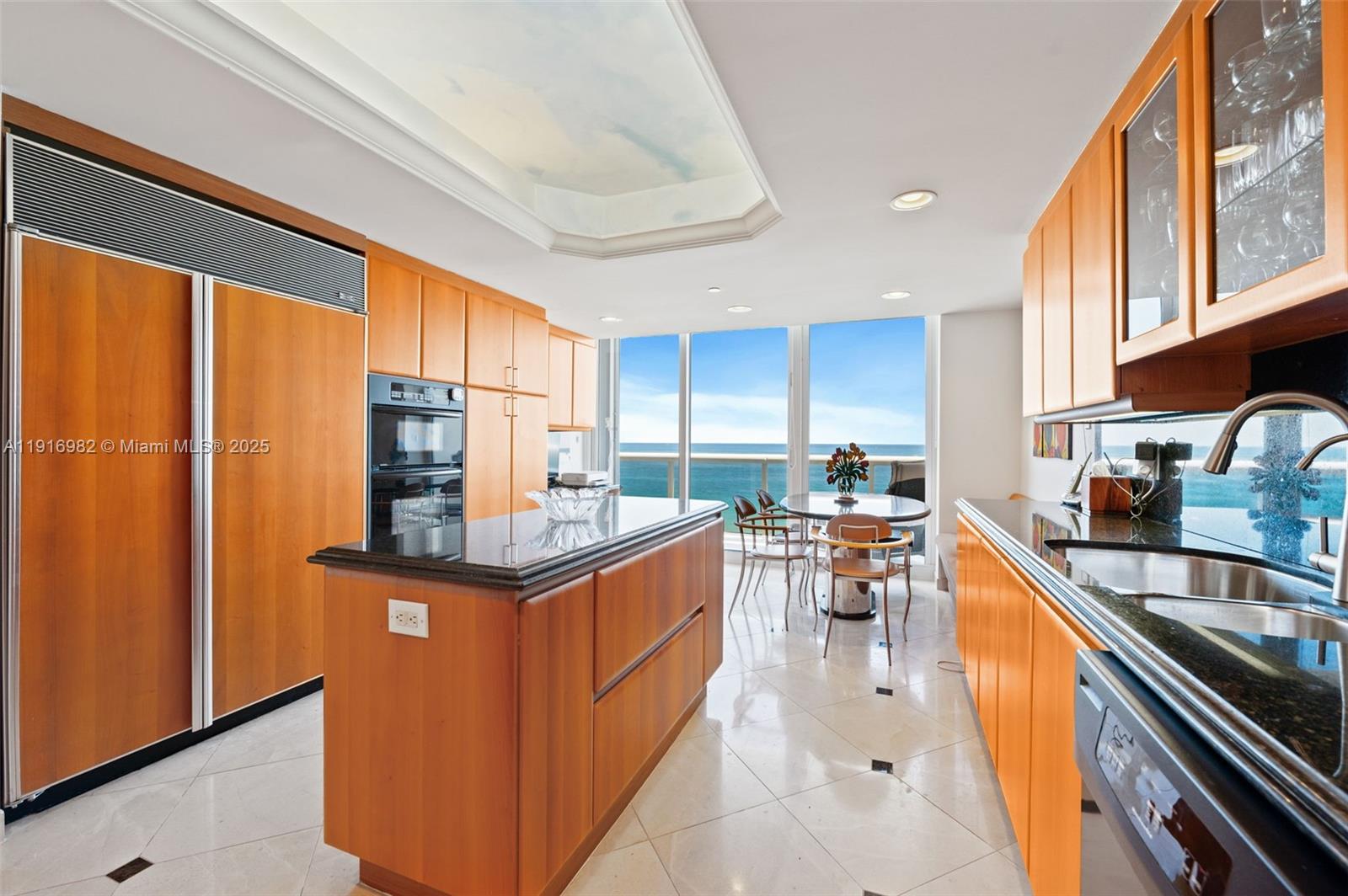 9595 Collins Avenue, Unit N8A Surfside, FL 33154 - Photo 10 of 25 a kitchen with stainless steel appliances granite countertop sink stove top oven and cabinets
