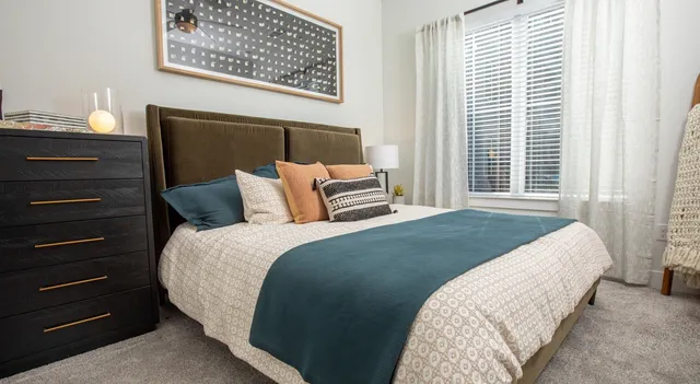 a bedroom with a bed and a dresser