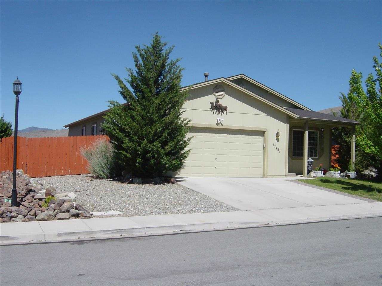 a front view of a house with a garden and yard