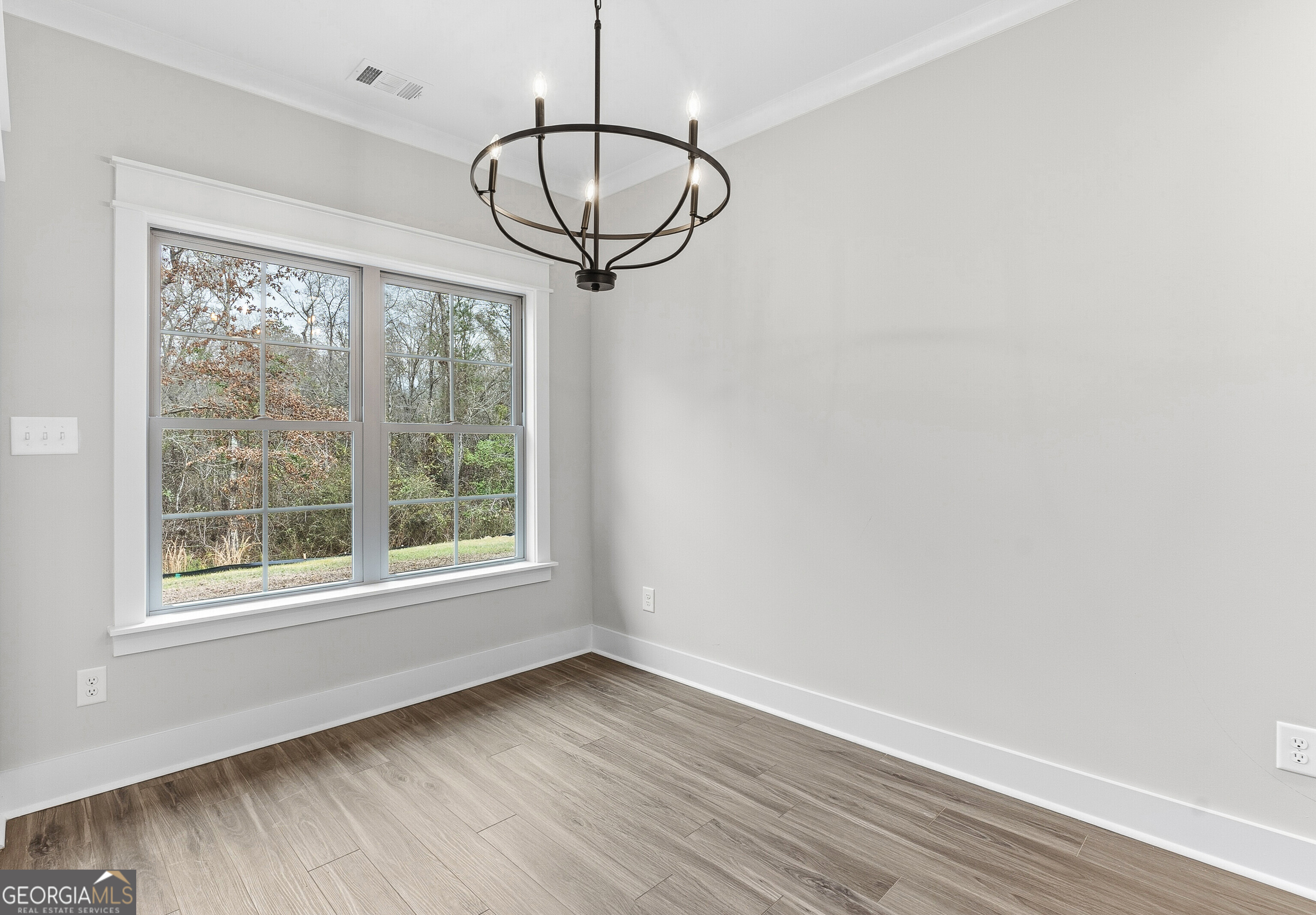 606 Bristleleaf Path Kathleen, GA 31047 - Photo 13 of 48 a view of a room with wooden floor exposed radiator and windows