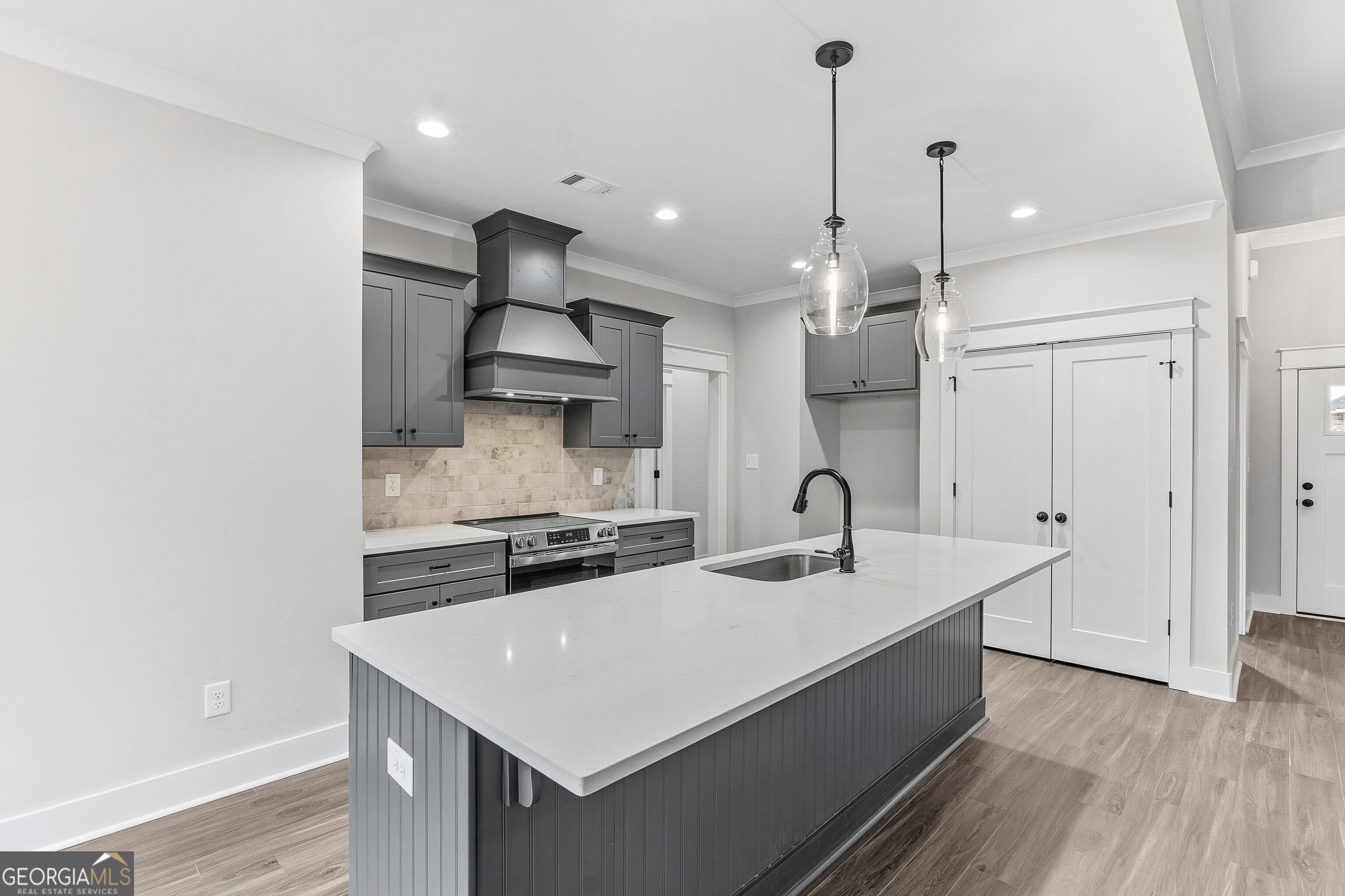 606 Bristleleaf Path Kathleen, GA 31047 - Photo 16 of 48 a kitchen with stainless steel appliances granite countertop a sink a refrigerator and a stove