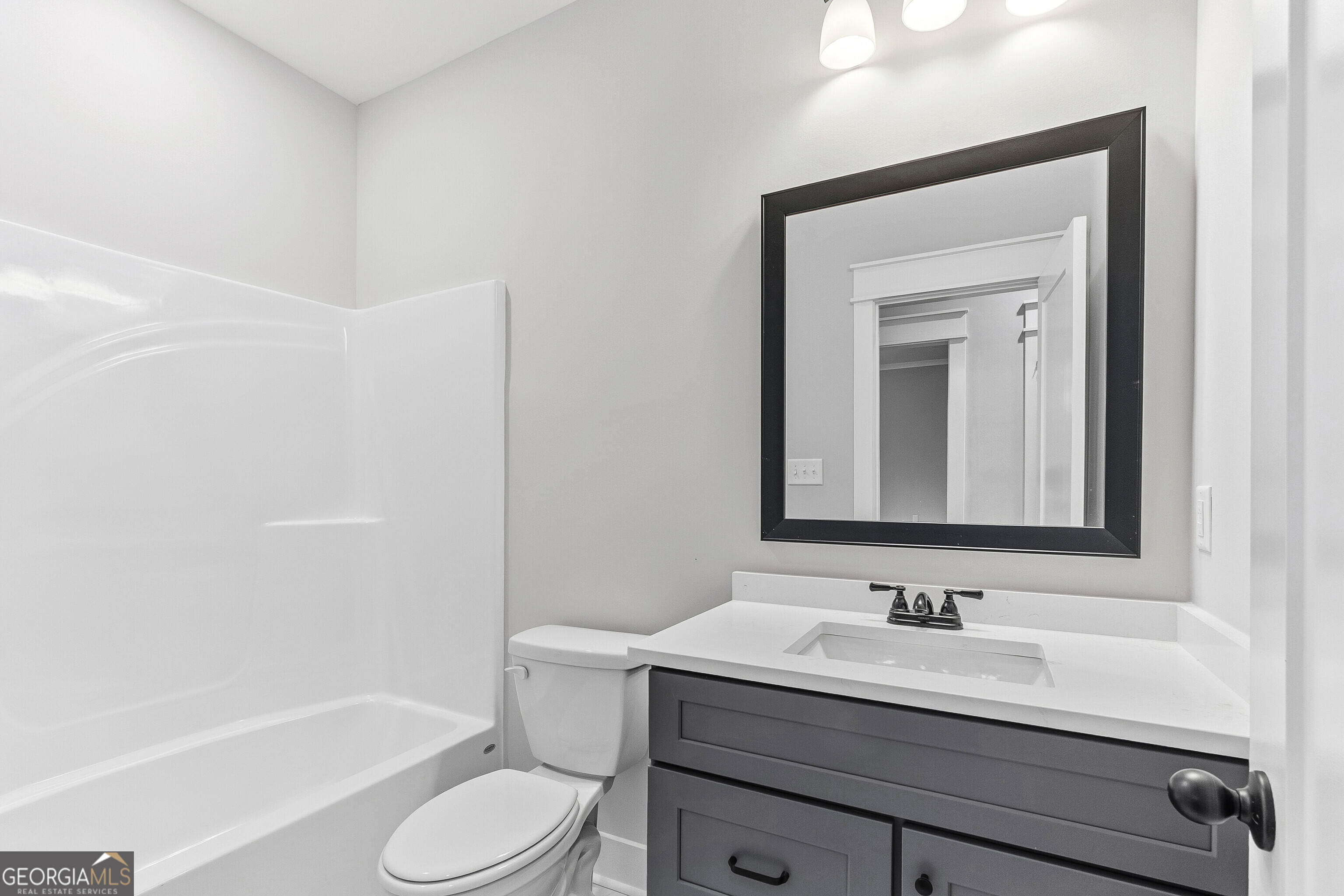 606 Bristleleaf Path Kathleen, GA 31047 - Photo 35 of 48 a bathroom with a sink toilet a mirror and shower