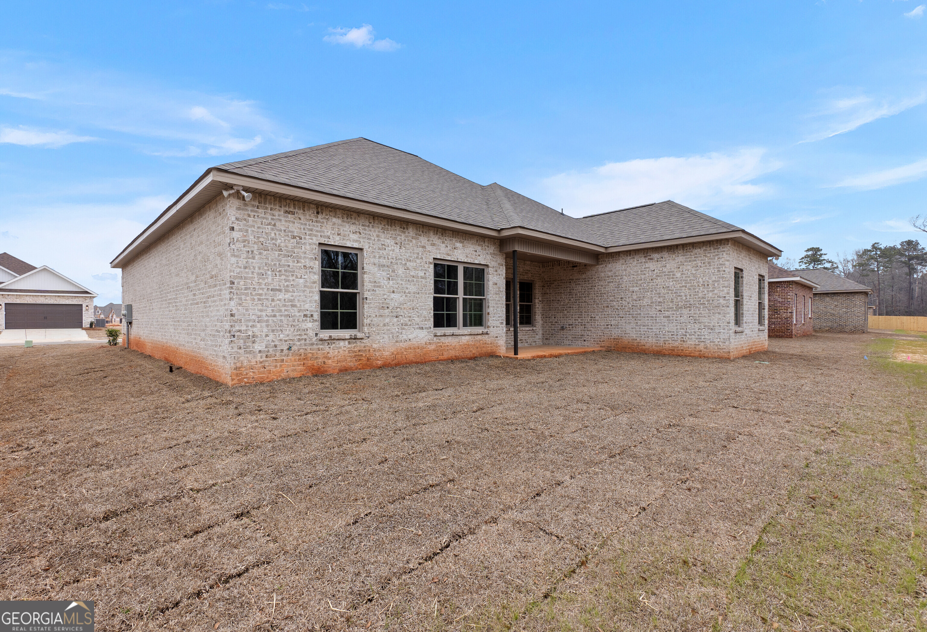 606 Bristleleaf Path Kathleen, GA 31047 - Photo 41 of 48 a house with white door of garage next to a yard