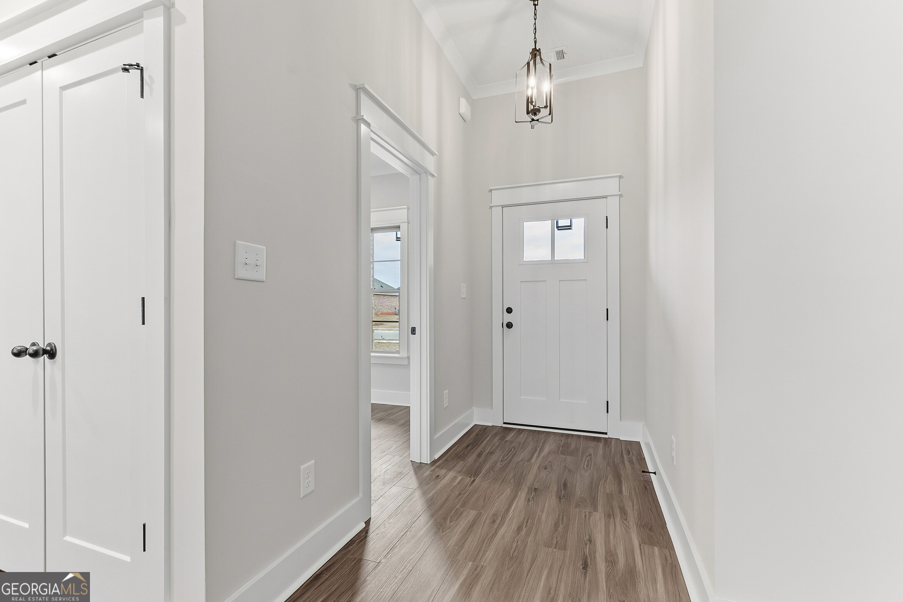 606 Bristleleaf Path Kathleen, GA 31047 - Photo 5 of 48 a view of a hallway with wooden floor and staircase