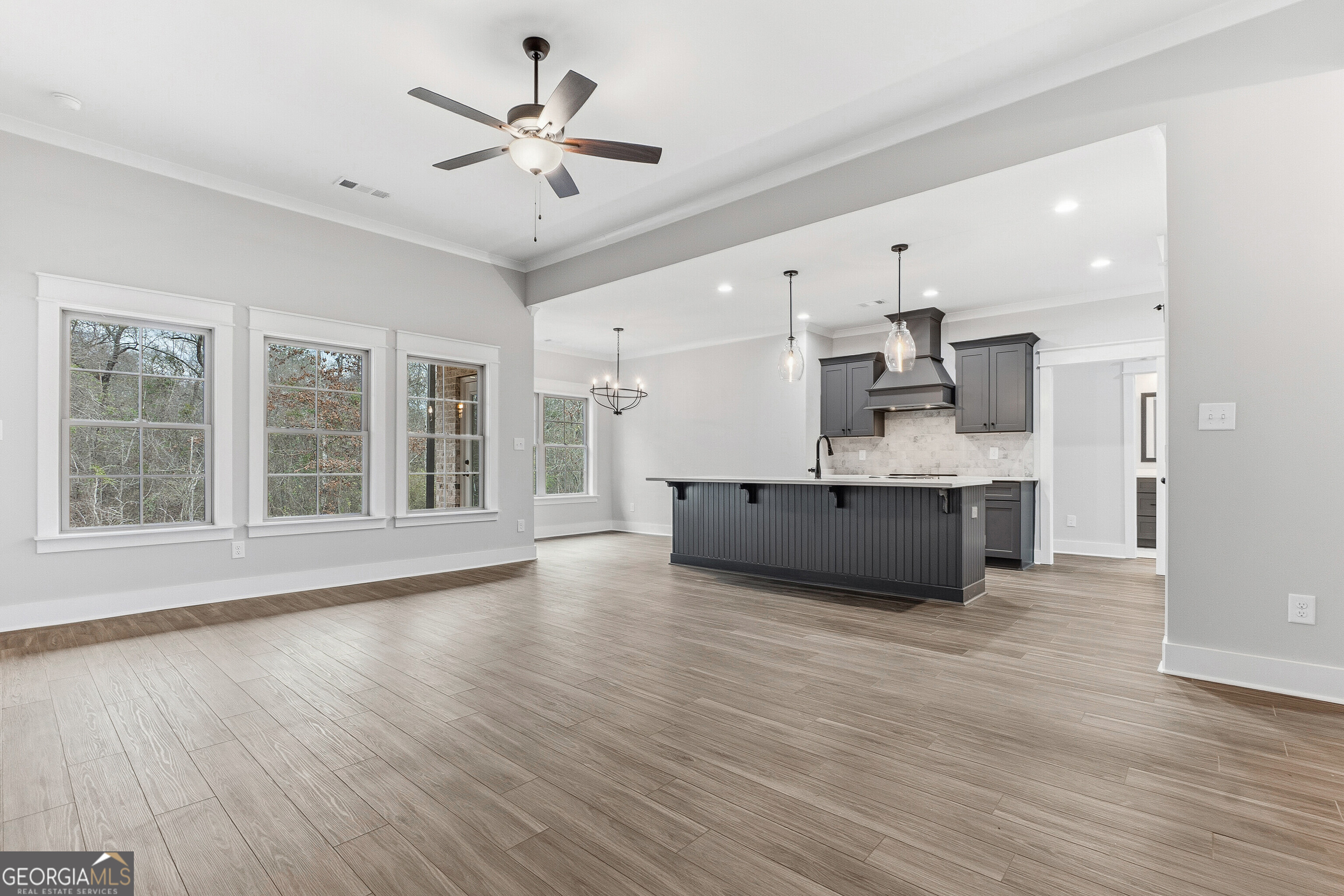 606 Bristleleaf Path Kathleen, GA 31047 - Photo 9 of 48 a large white kitchen with a large window and stainless steel appliances