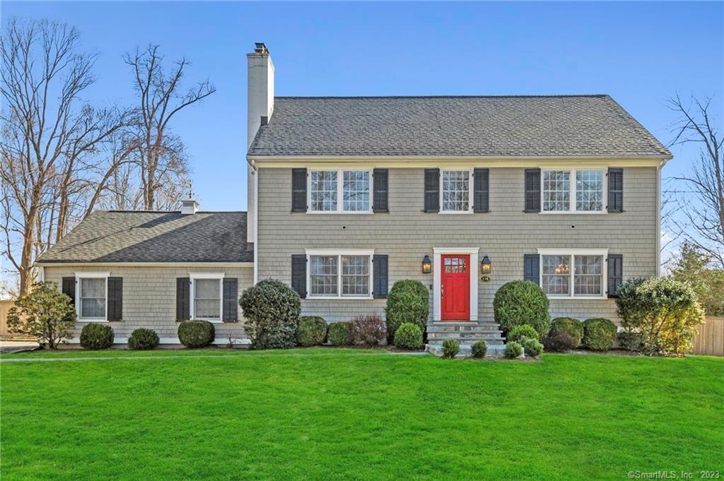 134 Silver Spring Lane Ridgefield, CT 06877 - Photo 1 of 1 a front view of a house with a garden and porch