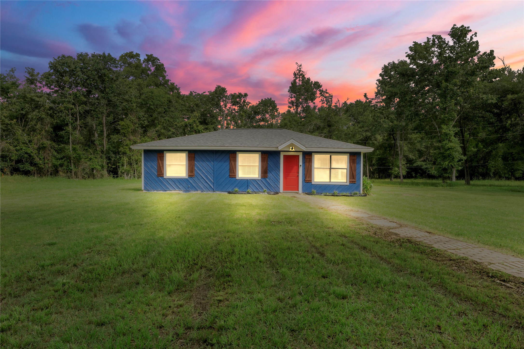 139 Holly Ridge Onalaska, TX 77360 - Photo 1 of 23 a front view of a house with yard and green space