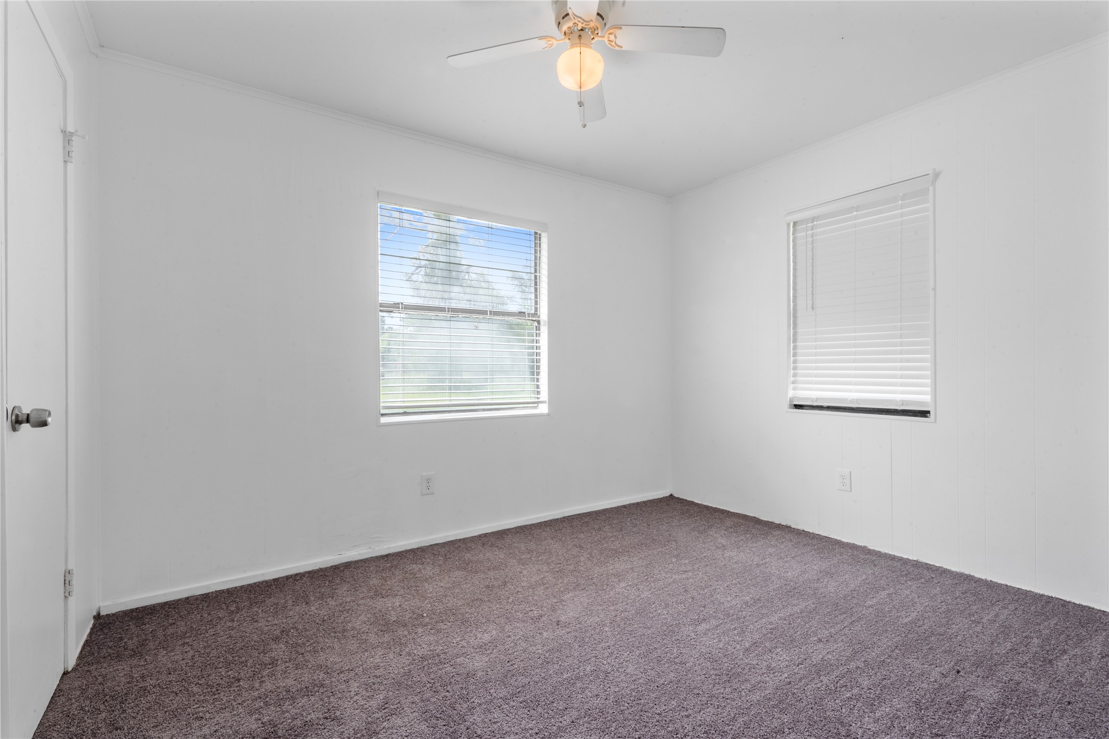139 Holly Ridge Onalaska, TX 77360 - Photo 13 of 23 an empty room with a chandelier fan and windows