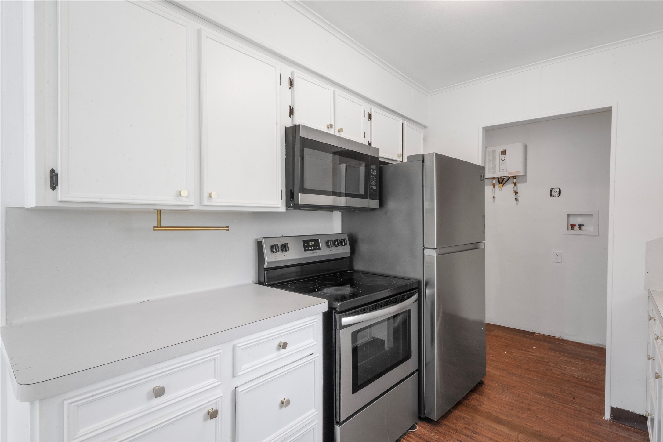 139 Holly Ridge Onalaska, TX 77360 - Photo 16 of 23 a kitchen with stainless steel appliances white cabinets white stove a refrigerator and a microwave