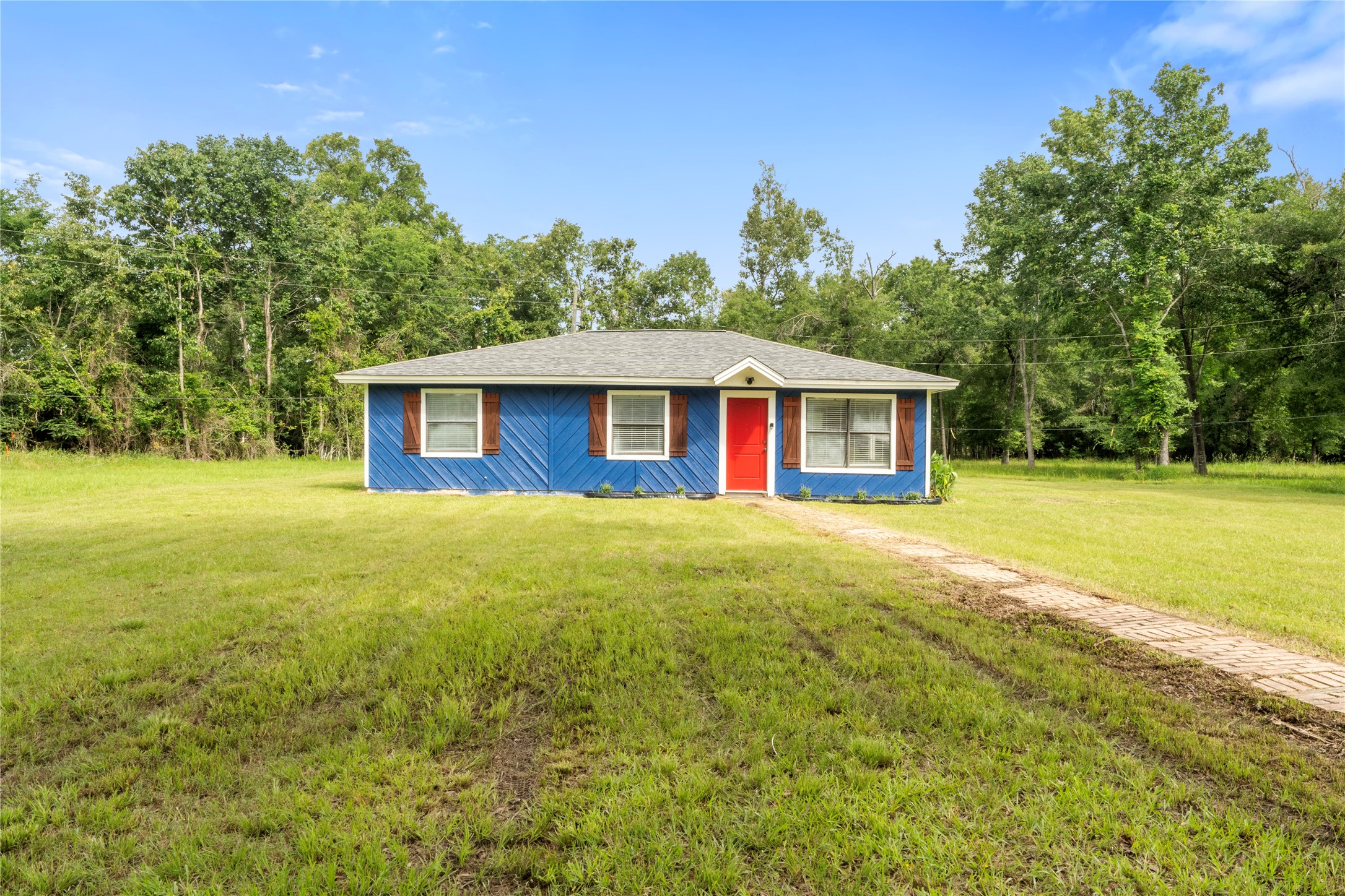 139 Holly Ridge Onalaska, TX 77360 - Photo 23 of 23 a view of a house with backyard and tree
