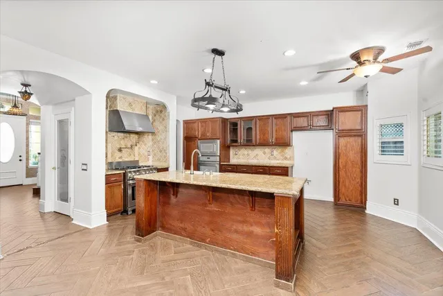 a kitchen with stainless steel appliances granite countertop a refrigerator and a sink