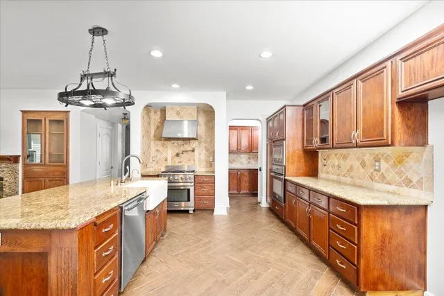 a large kitchen with kitchen island granite countertop a sink and a refrigerator