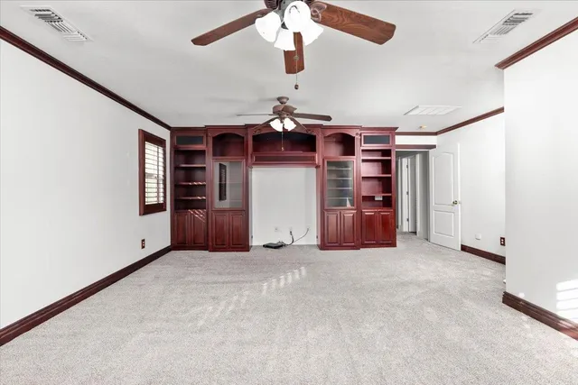 en empty room with closet and windows