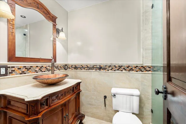 a bathroom with a sink a toilet and a mirror