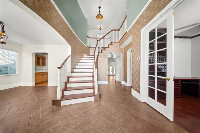a view of a hallway with wooden floor and entryway