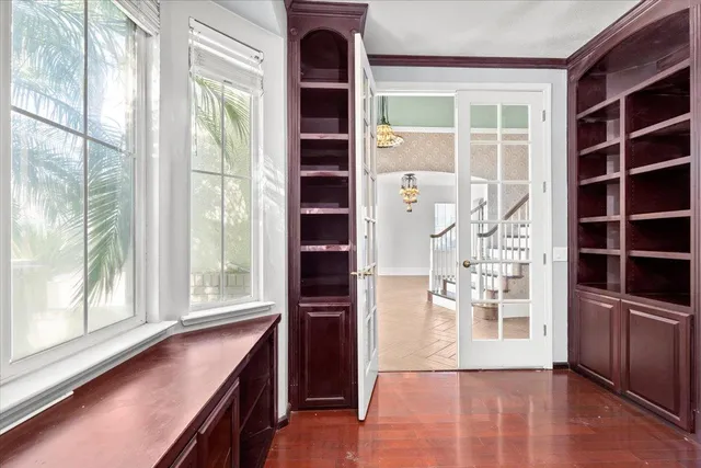 a view of wooden floor and windows in a room