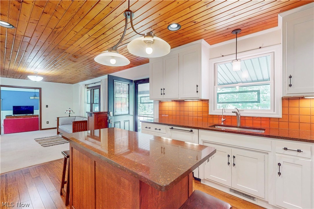 86532 North Bay Road Scio, OH 43988 - Photo 22 of 48 Kitchen featuring wood-paneled ceiling, white cabinetry, dark countertops, and a tiled backsplash