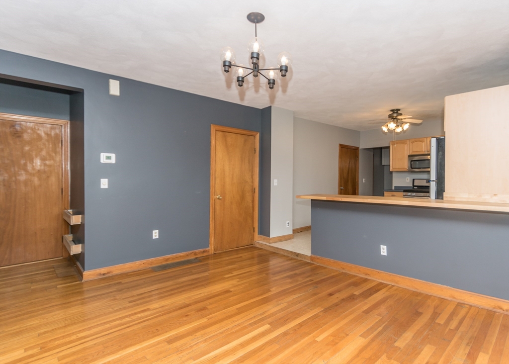 17 Cleveland Avenue, Unit 1 Everett, MA 02149 - Photo 12 of 20 a view of a room with a chandelier and wooden floor