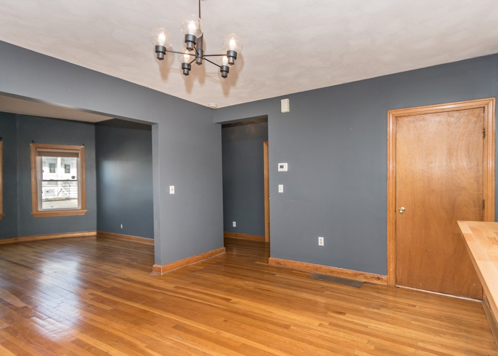 17 Cleveland Avenue, Unit 1 Everett, MA 02149 - Photo 13 of 20 a view of an empty room with wooden floor and a ceiling fan