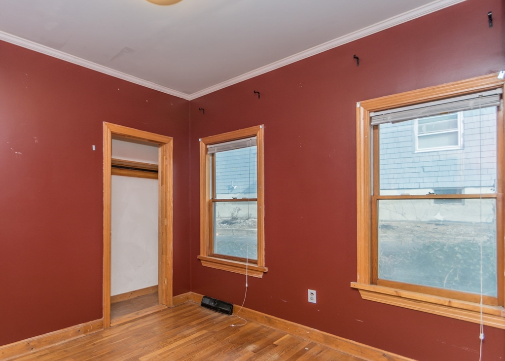 17 Cleveland Avenue, Unit 1 Everett, MA 02149 - Photo 15 of 20 a view of an empty room with wooden floor and windows