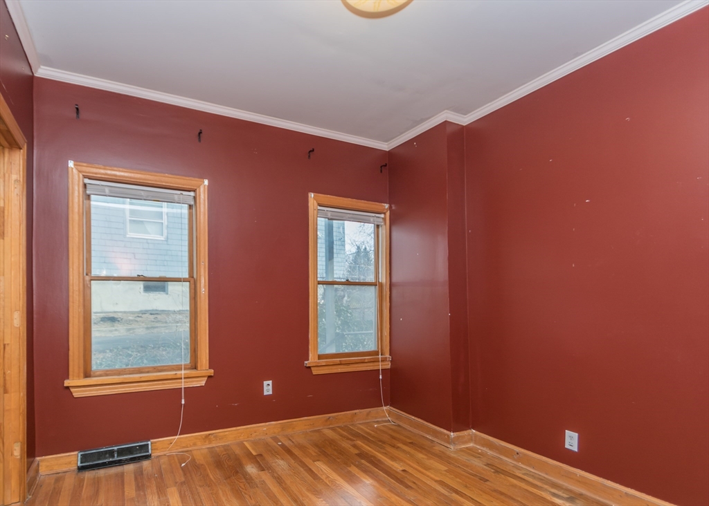 17 Cleveland Avenue, Unit 1 Everett, MA 02149 - Photo 16 of 20 a view of empty room with window and wooden floor