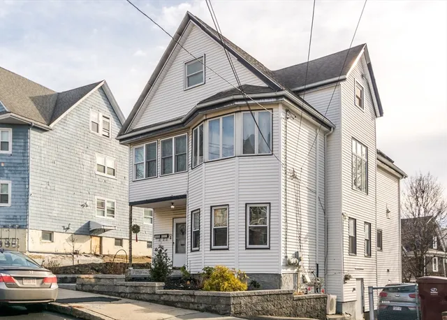 a front view of a residential apartment building with a street