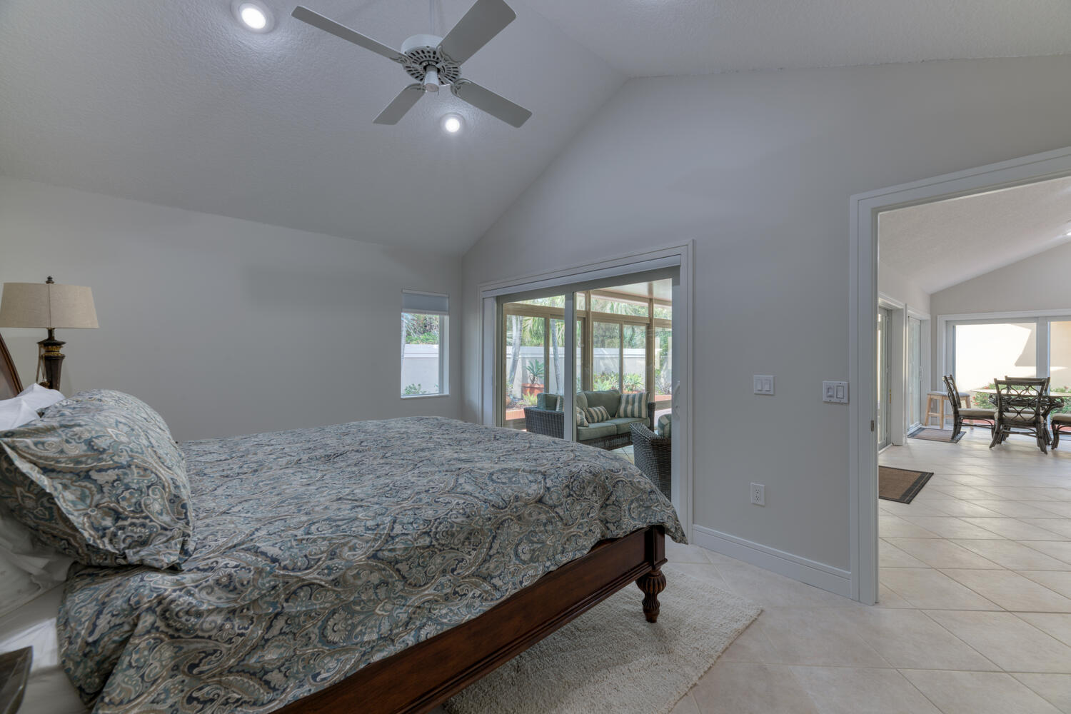 108 Seashore Drive Jupiter, FL 33477 - Photo 12 of 42 a bedroom with a bed and a chandelier