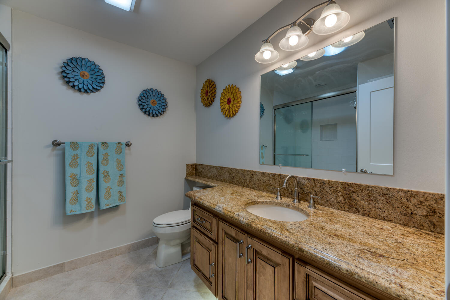 108 Seashore Drive Jupiter, FL 33477 - Photo 19 of 42 a bathroom with a granite countertop sink a toilet and mirror