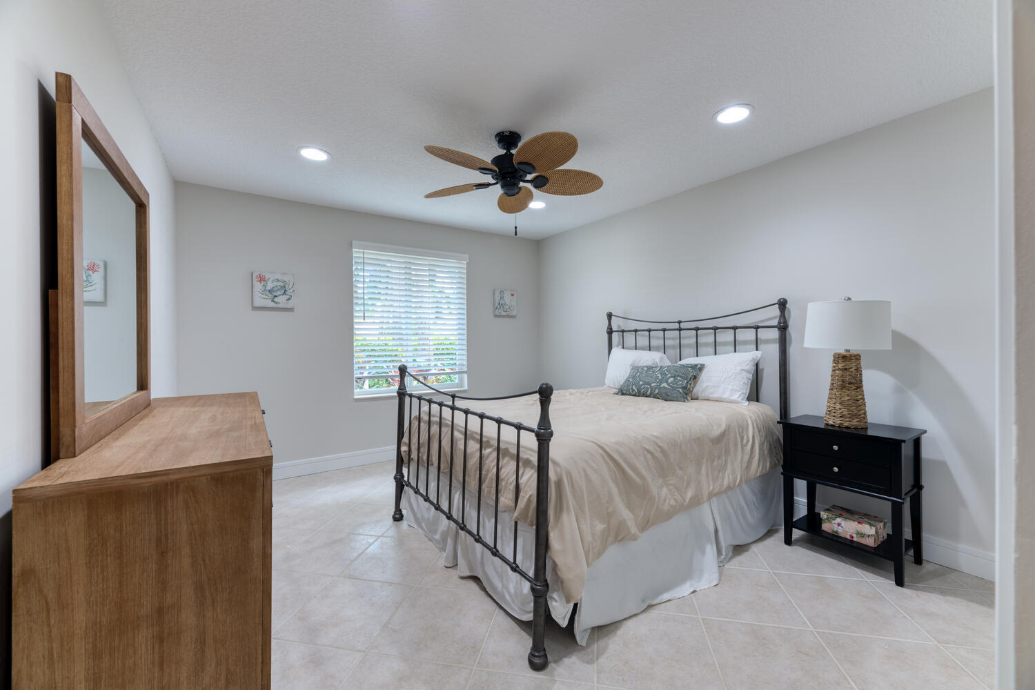 108 Seashore Drive Jupiter, FL 33477 - Photo 20 of 42 a bedroom with a bed and a ceiling fan