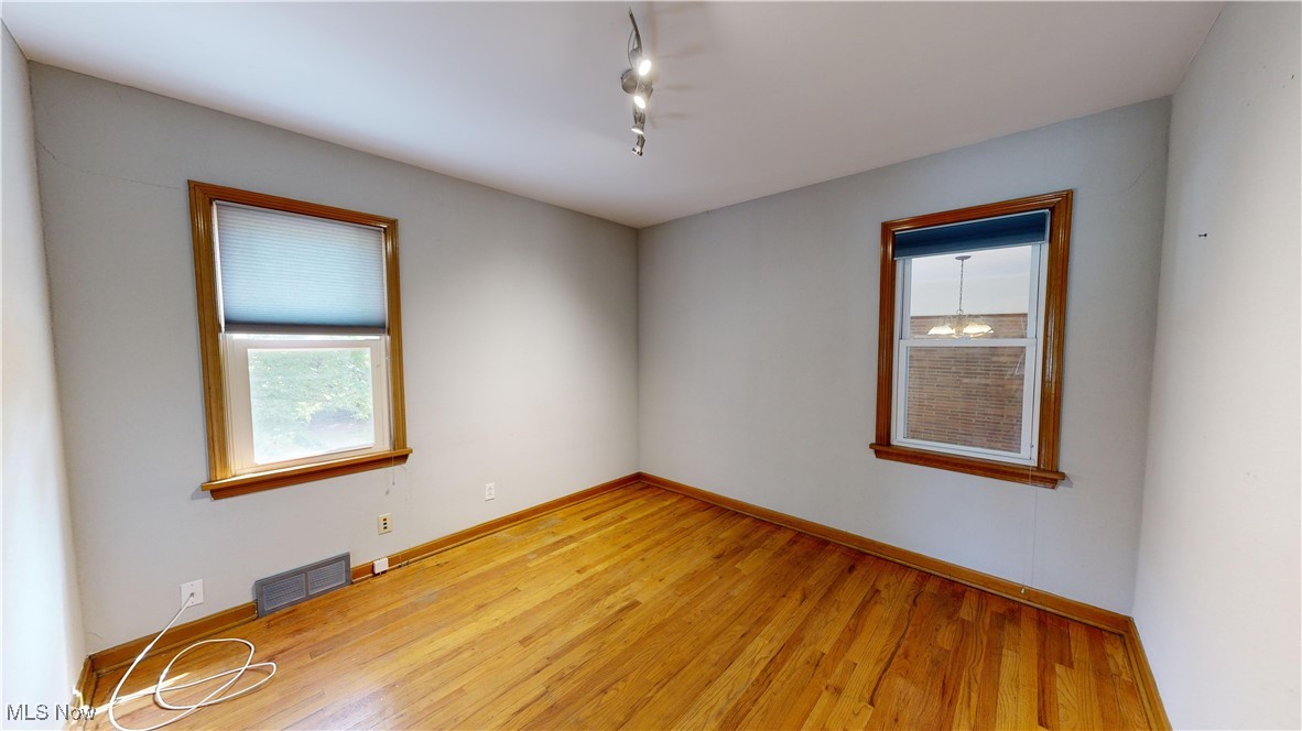 29280 White Road Wickliffe, OH 44092 - Photo 12 of 43 Bedroom featuring rail lighting and light wood-type flooring