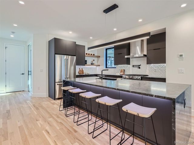 a kitchen with granite countertop lots of counter top space and stainless steel appliances