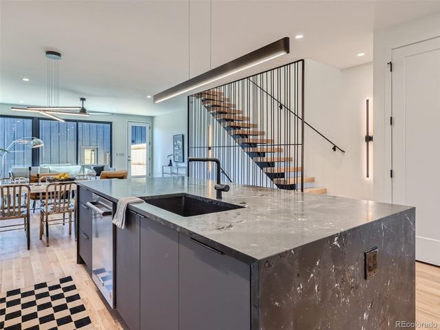 a kitchen with a stove a sink and a refrigerator