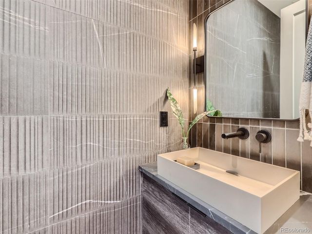 a bathroom with a sink a toilet and mirror