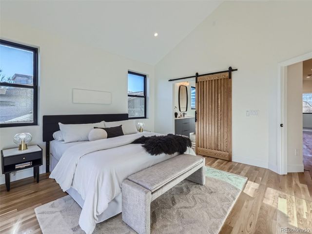 a bedroom with a bed and a night stand