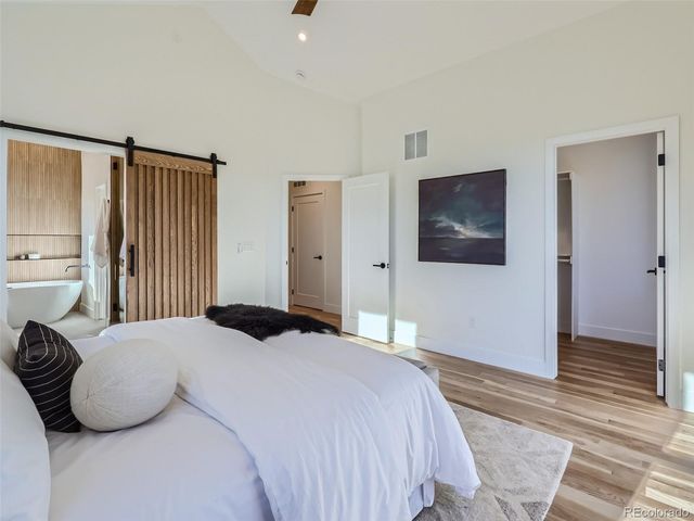 a bedroom with a bed and a view of bathroom