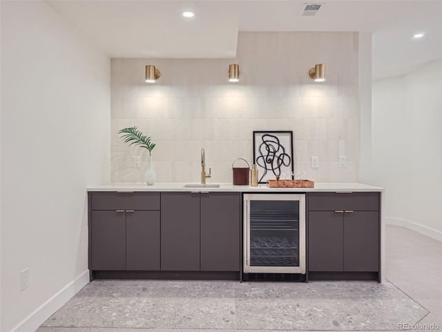 a large room with stainless steel appliances kitchen island sink and stove