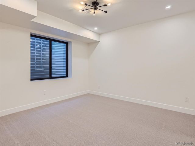 an empty room with a ceiling fan and window