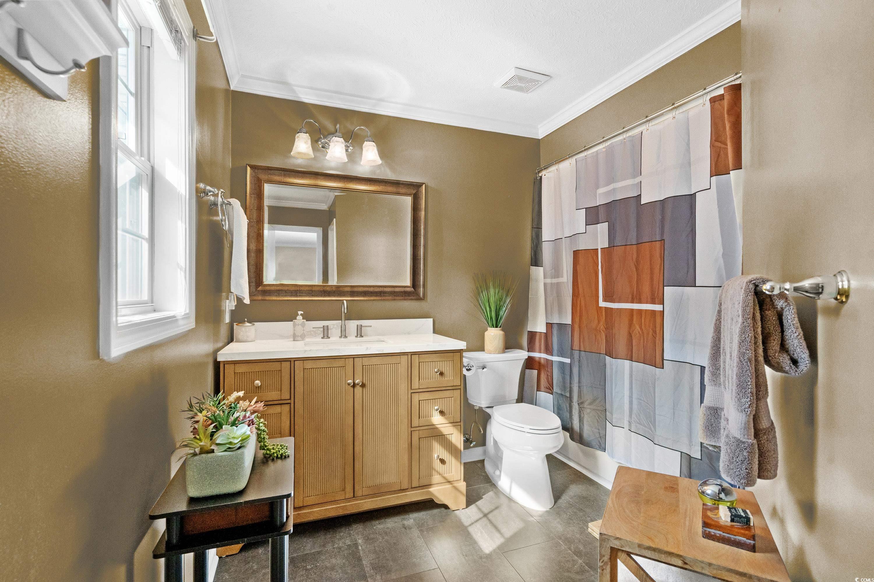 1869 Meadowood Lane Longs, SC 29568 - Photo 14 of 37 Full bathroom with visible vents, toilet, vanity, crown molding, and a shower with shower curtain
