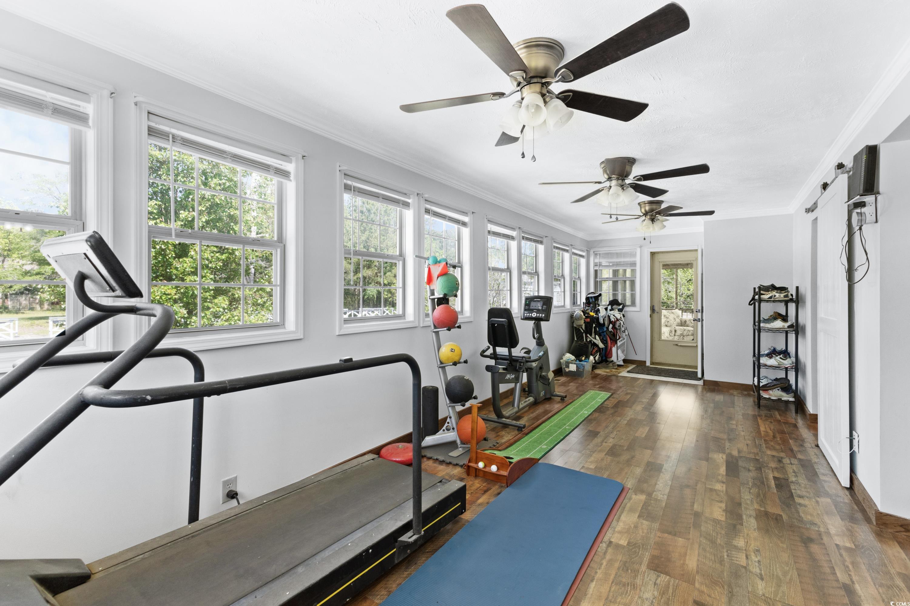 1869 Meadowood Lane Longs, SC 29568 - Photo 16 of 37 Workout room featuring wood-type flooring, ceiling fan, and crown molding