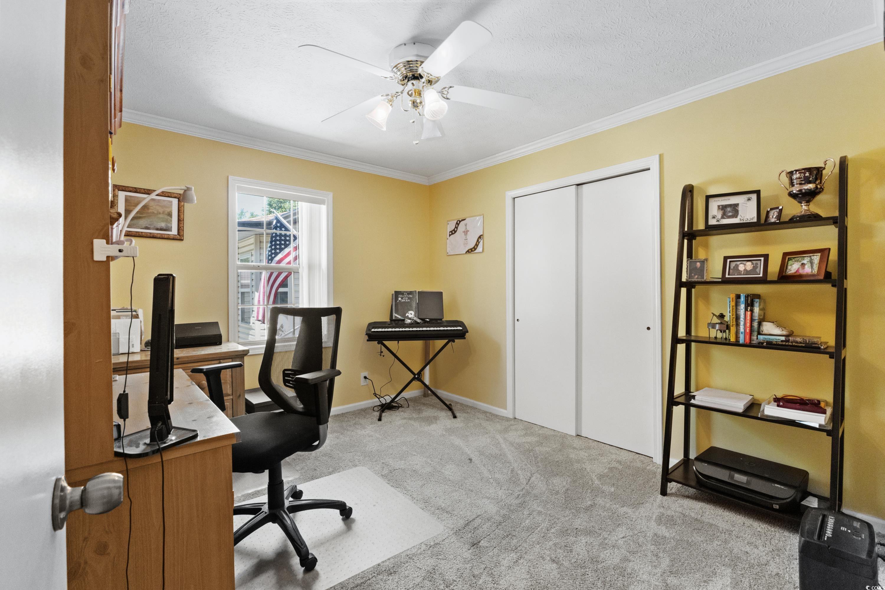 1869 Meadowood Lane Longs, SC 29568 - Photo 17 of 37 Home office featuring baseboards, crown molding, a ceiling fan, and light carpet