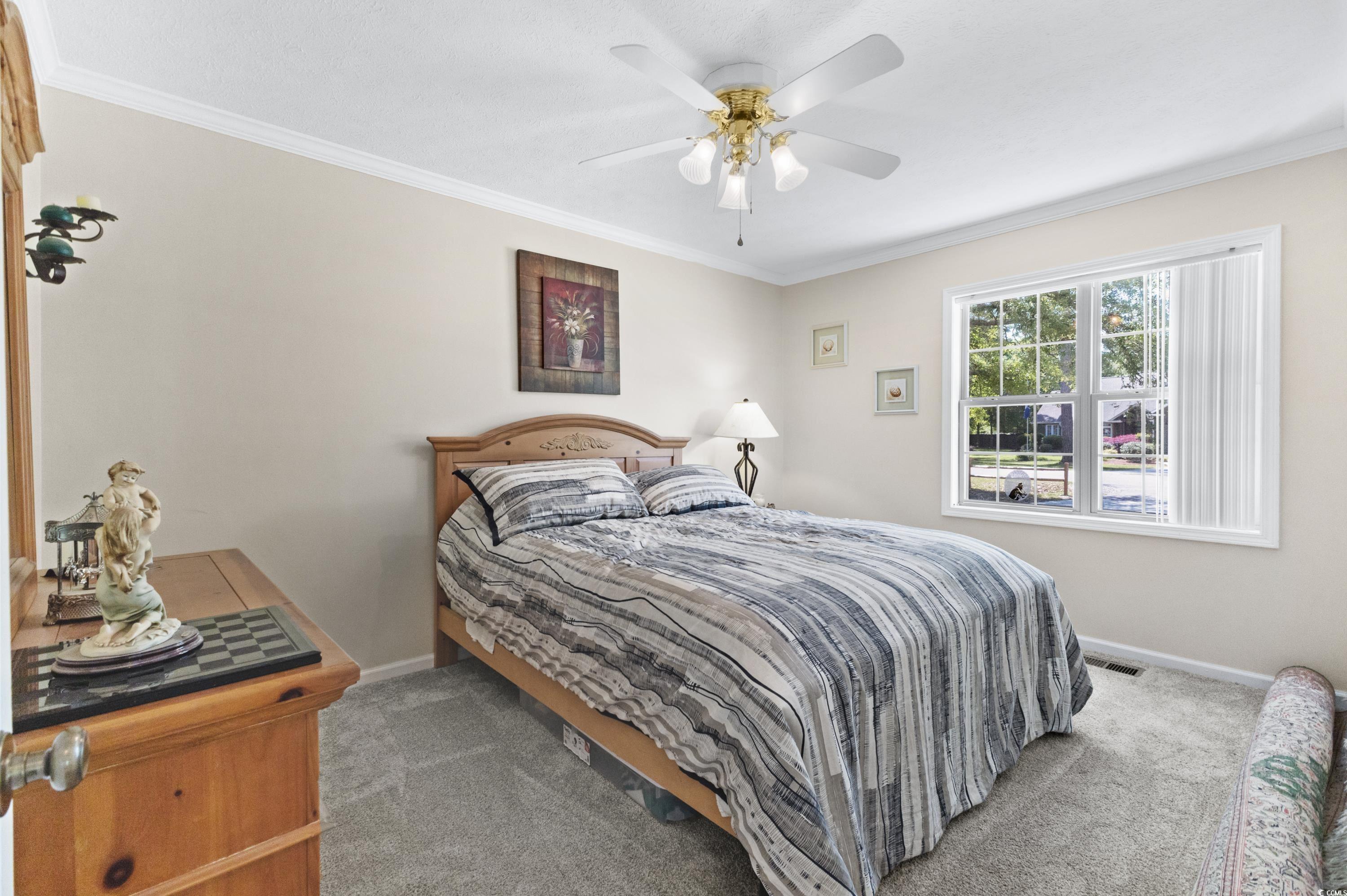 1869 Meadowood Lane Longs, SC 29568 - Photo 19 of 37 Bedroom featuring baseboards, ornamental molding, carpet flooring, and visible vents